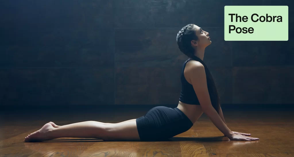 a women doing the cobra pose in a dark room